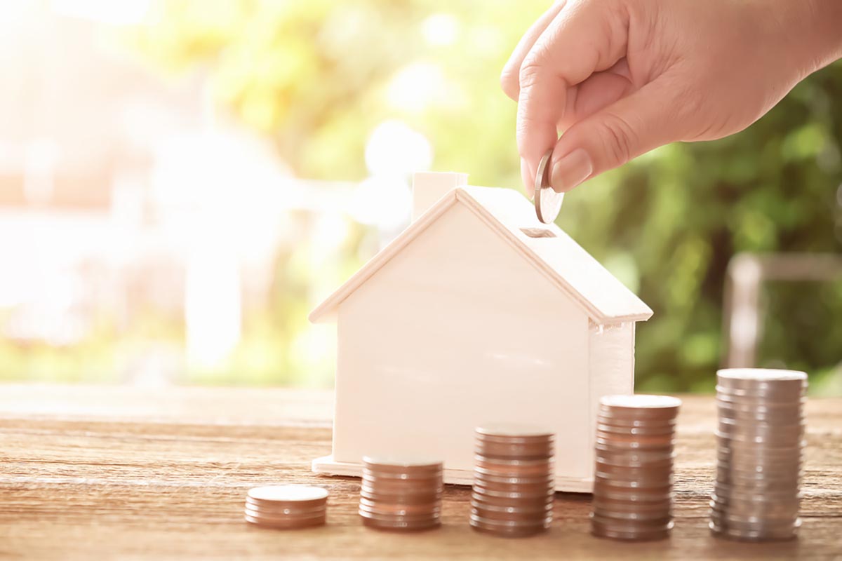 Hand,Putting,Coin,In,House,Model,Of,Coin,For,Saving C&N Accountants - Hand putting coins on a house-modeled coinbank, representing property investments