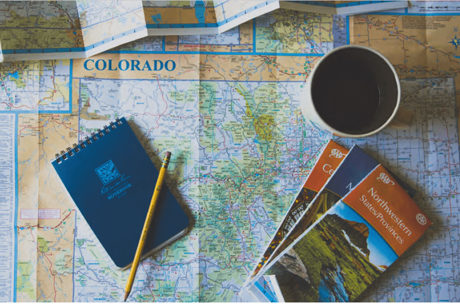 Travel-Agent-min Travel brochures on top of a paper map